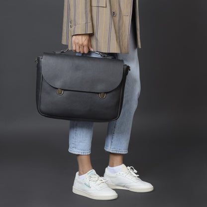 Model holding London Leather Briefcase Handcrafted with Natural and Sustainable Materials including Spacious Laptop Compartment